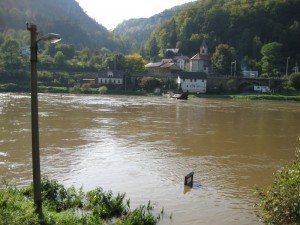 View of the flooded river, with ferryboat sign nearly submerged