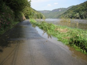 Flood water creeps up onto the cycle path