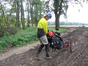 Zach drags his trike through the mud